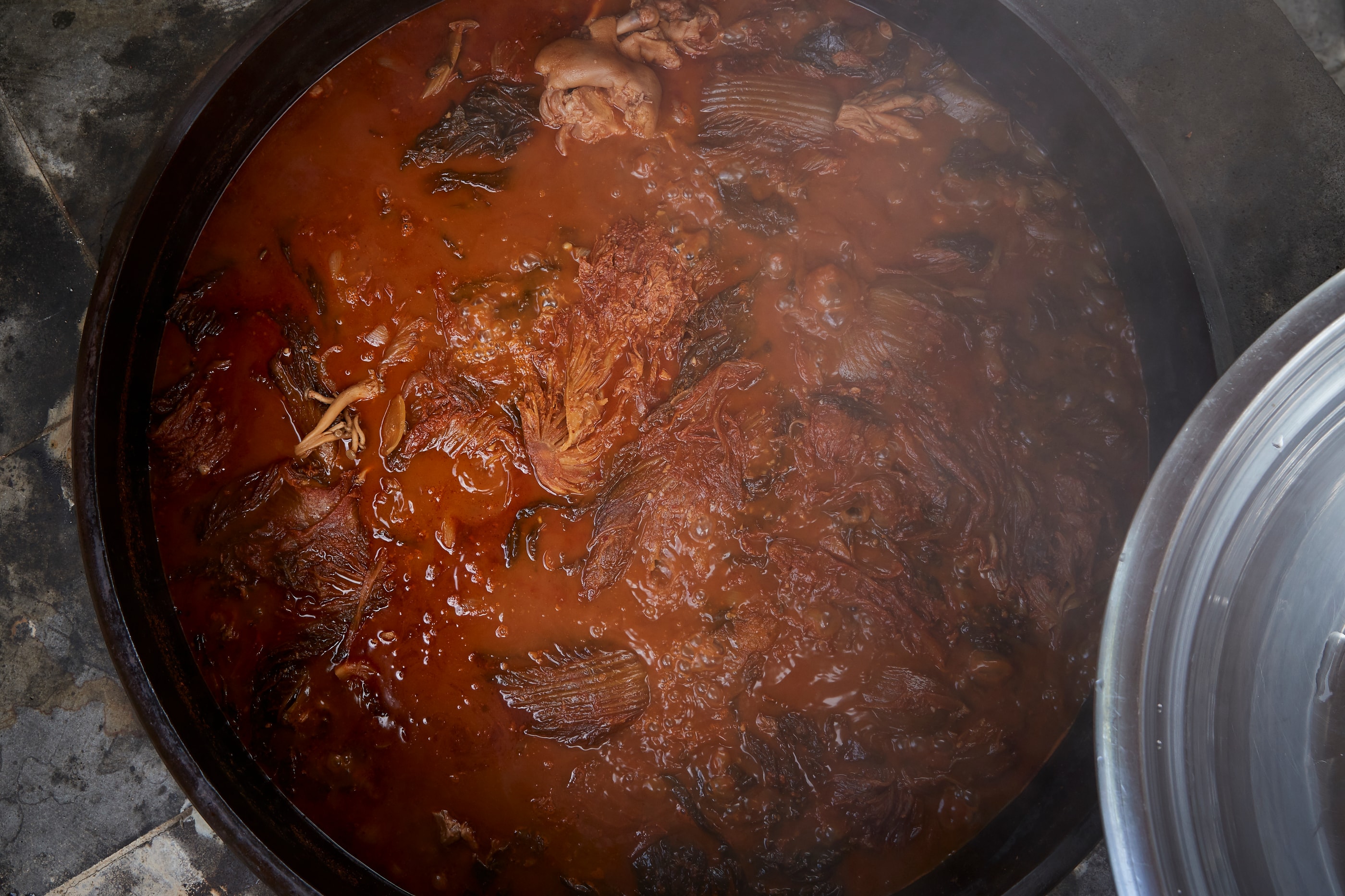 The Hwang family at work — slow hands in a kitchen that has cooked this way for decades.